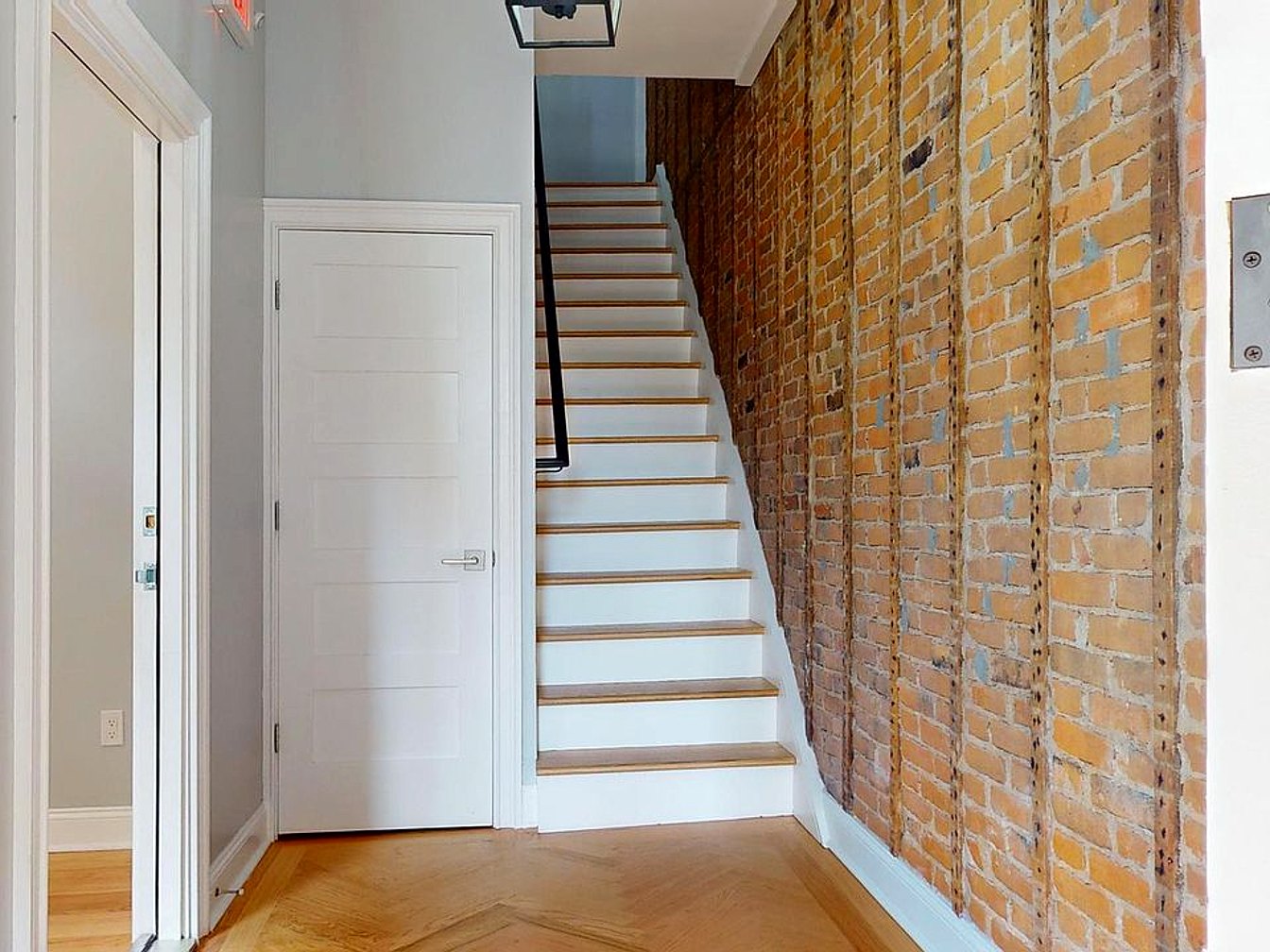 St. John Row Homes — exposed-brick stairwell