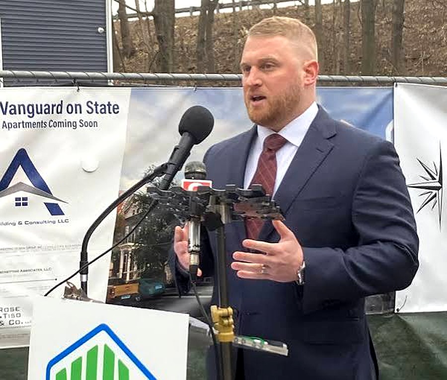 Vanguard principal speaking at a press event